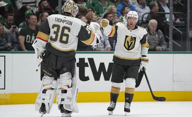 Vegas Golden Knights right wing Jonathan Marchessault, right, celebrates his first period goal with goaltender Logan Thompson (36) during Game 2 of an NHL hockey Stanley Cup first-round playoff series against the Dallas Stars in Dallas, Wednesday, April 24, 2024. (AP Photo/Tony Gutierrez)