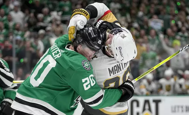 Dallas Stars defenseman Ryan Suter (20) and Vegas Golden Knights right wing Anthony Mantha (39) scuffle during the second period in Game 2 of an NHL hockey Stanley Cup first-round playoff series in Dallas, Wednesday, April 24, 2024. (AP Photo/Tony Gutierrez)