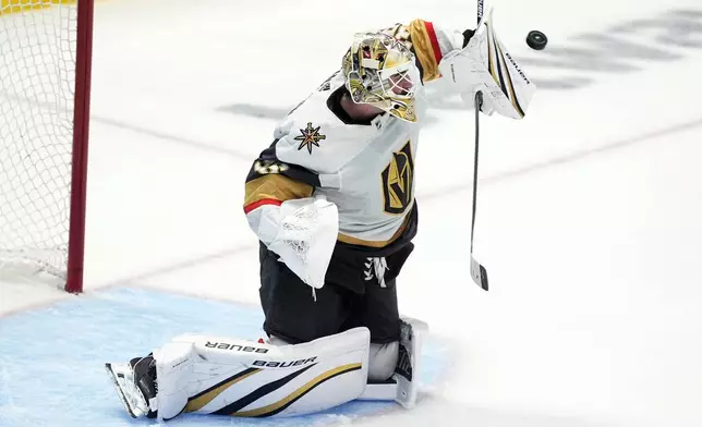Vegas Golden Knights goaltender Logan Thompson blocks a shot from the Dallas Stars in the third period in Game 1 of an NHL hockey Stanley Cup first-round playoff series in Dallas, Monday, April 22, 2024. (AP Photo/Tony Gutierrez)