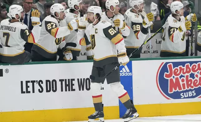 Vegas Golden Knights right wing Mark Stone (61) celebrates with the bench after scoring in the first period in Game 1 of an NHL hockey Stanley Cup first-round playoff series against the Dallas Stars in Dallas, Monday, April 22, 2024. (AP Photo/Tony Gutierrez)