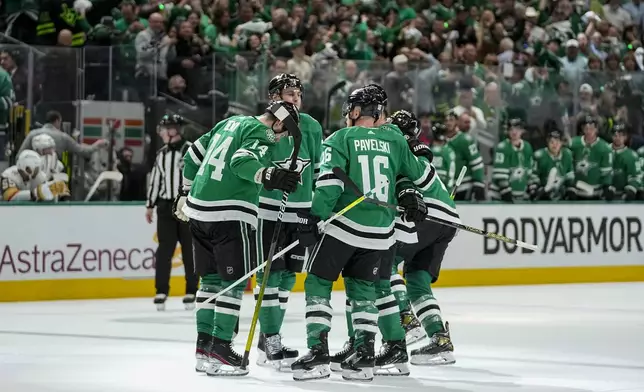 Dallas Stars players celebrate a first period power play goal by Jason Robertson, not visible, during Game 2 of an NHL hockey Stanley Cup first-round playoff series against the Vegas Golden Knights in Dallas, Wednesday, April 24, 2024. (AP Photo/Tony Gutierrez)