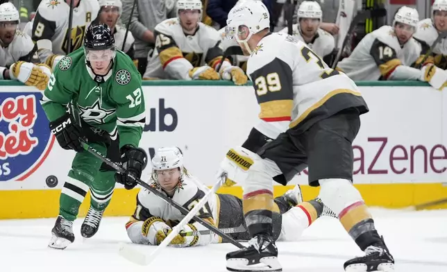 Dallas Stars center Radek Faksa (12) looks to take control of the puck in front of Vegas Golden Knights' Anthony Mantha (39) and William Karlsson (71) in the second period in Game 1 of an NHL hockey Stanley Cup first-round playoff series in Dallas, Monday, April 22, 2024. (AP Photo/Tony Gutierrez)
