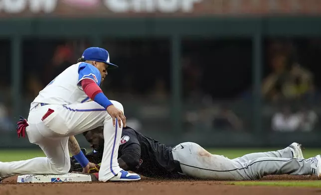 Atlanta Braves shortstop Orlando Arcia (11) tags out Cleveland Guardians outfielder Estevan Florial (90) in the second inning of a baseball game, Saturday, April 27, 2024, in Atlanta. (AP Photo/Mike Stewart)