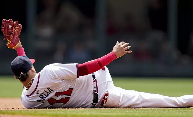 Atlanta Braves shortstop Orlando Arcia (11) holds the ball high after tagging out Cleveland Guardians' Tyler Freeman at second base in the fourth inning of a baseball game, Sunday, April 28, 2024, in Atlanta. (AP Photo/Mike Stewart)