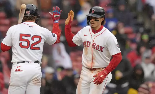 Boston Red Sox's Jarren Duran, right, celebrates with Wilyer Abreu, left, after scoring on a balk in the sixth inning of a baseball game against the Cleveland Guardians, Thursday, April 18, 2024, in Boston. (AP Photo/Steven Senne)