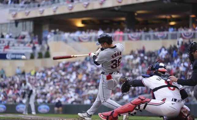 Cleveland Guardians' Steven Kwan (38) hits a double during the fifth inning of a baseball game against the Minnesota Twins, Thursday, April 4, 2024, in Minneapolis. (AP Photo/Abbie Parr)
