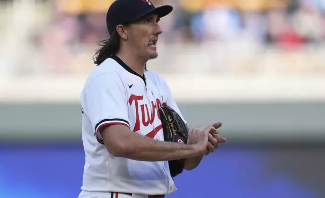 Minnesota Twins relief pitcher Kody Funderburk reacts after issuing a walk to Cleveland Guardians' David Fry during the eighth inning of a baseball game Thursday, April 4, 2024, in Minneapolis. (AP Photo/Abbie Parr)