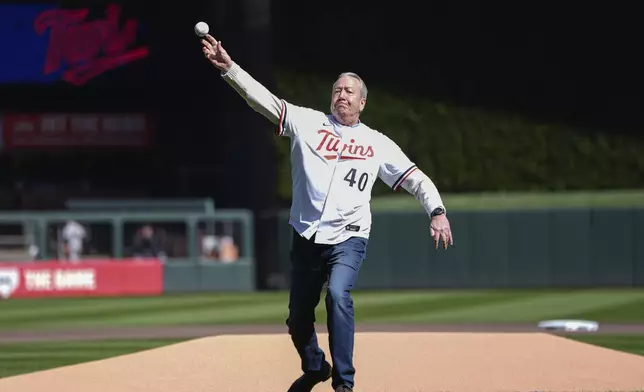 Former Minnesota Twins broadcaster Dick Bremer delivers the ceremonial first pitch before the baseball team's home-opener against the Cleveland Guardians, Thursday, April 4, 2024, in Minneapolis. (AP Photo/Abbie Parr)