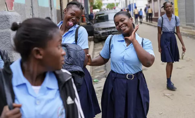 Students strike poses at the end of their school day, in Cap-Haitien, Haiti, Wednesday, April 17, 2024. (AP Photo/Ramon Espinosa)
