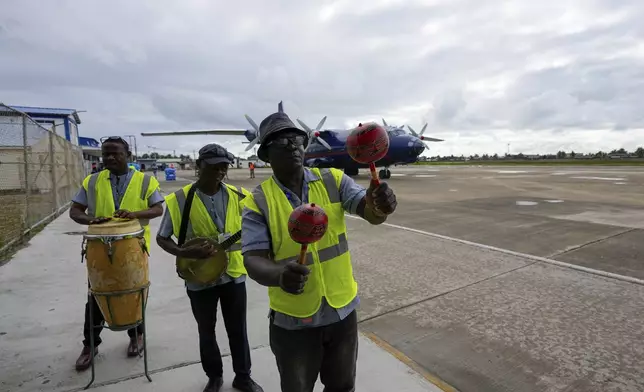 A band plays for arriving passengers at the airport in Cap-Haitien, Haiti, Wednesday, April 17, 2024. (AP Photo/Ramon Espinosa)