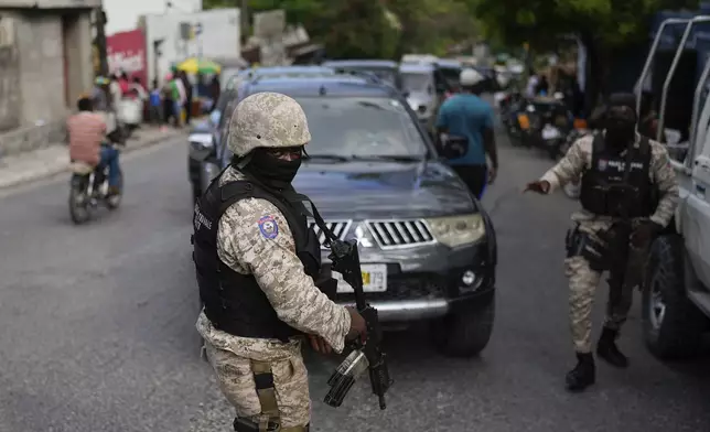 Soldiers deploy outside the Prime Minister's office in Port-au-Prince, Haiti, in preparation for the swearing-in of a transitional council tasked with selecting a new prime minister and cabinet, Thursday, April 25, 2024. (AP Photo/Ramon Espinosa)
