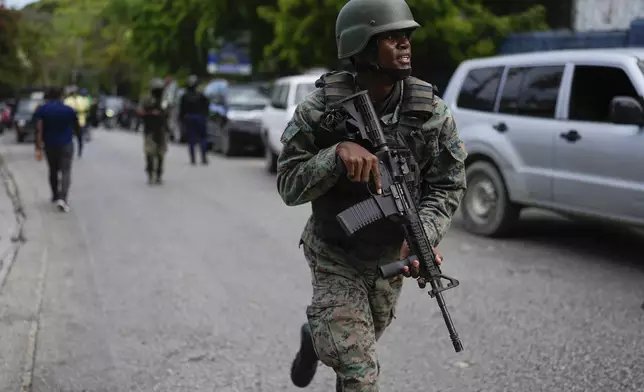 Soldiers deploy outside the Prime Minister's office in Port-au-Prince, Haiti, Thursday, April 25, 2024. A transitional council tasked with selecting a new prime minister and cabinet is expected to be sworn-in on Thursday. (AP Photo/Ramon Espinosa)