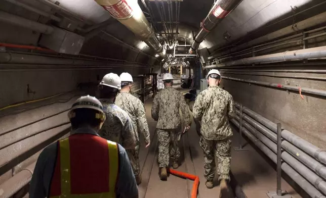 FILE - In this photo provided by the U.S. Navy, Rear Adm. John Korka, Commander, Naval Facilities Engineering Systems Command (NAVFAC), and Chief of Civil Engineers, leads Navy and civilian water quality recovery experts through the tunnels of the Red Hill Bulk Fuel Storage Facility, near Pearl Harbor, Hawaii, on Dec. 23, 2021. A trial is set to start on Monday, April 29, 2024, in a case surrounding the 2021 leaked jet fuel into the Navy water system that serves 93,000 people on and around the Pearl Harbor base. There are 17 people suing the United States over the leak and continuing health problems they argue are tied to the tainted water. (Mass Communication Spc. 1st Class Luke McCall/U.S. Navy via AP, File)