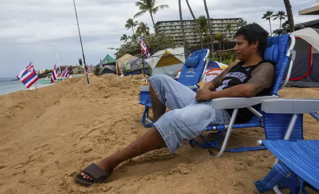 FILE - Carlos Lamas looks out to the sea from his spot at the "Fish-in" protest on, Friday, Dec. 1, 2023, in Lahaina, Hawaii. Lahaina Strong has set up a "Fish-in" to protest living accommodations for those displaced by the Aug. 8, 2023 wildfire, the deadliest U.S. wildfire in more than a century. (AP Photo/Ty O'Neil, File)