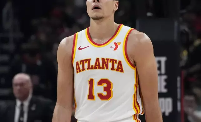 Atlanta Hawks guard Bogdan Bogdanovic looks up the scoreboard as he walks to the bench during the first half of the team's NBA basketball play-in tournament game against the Chicago Bulls in Chicago, Wednesday, April 17, 2024. (AP Photo/Nam Y. Huh)