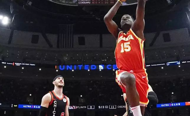 Atlanta Hawks center Clint Capela (15) drives to the basket past Chicago Bulls guard Alex Caruso during the first half of an NBA basketball game in Chicago, Monday, April 1, 2024. (AP Photo/Nam Y. Huh)