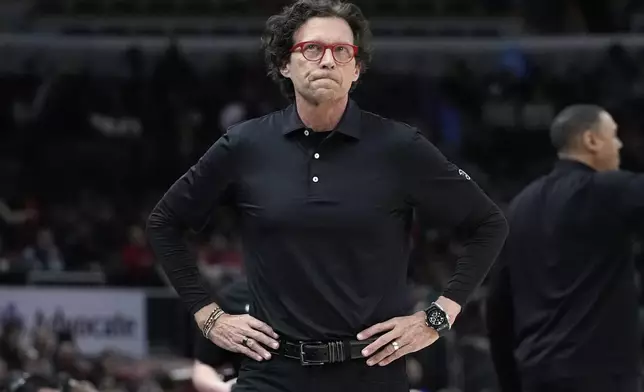 Atlanta Hawks head coach Quin Snyder checks the score board during the first half of an NBA basketball game against the Chicago Bulls in Chicago, Monday, April 1, 2024. (AP Photo/Nam Y. Huh)