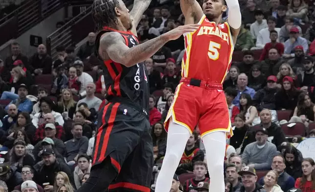 Atlanta Hawks guard Dejounte Murray, right, shoots over Chicago Bulls forward DeMar DeRozan during the first half of an NBA basketball game in Chicago, Monday, April 1, 2024. (AP Photo/Nam Y. Huh)