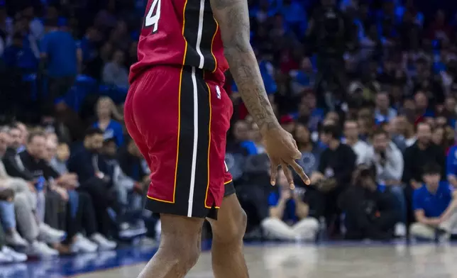 Miami Heat's Delon Wright reacts to his 3-point shot during the first half of the team's NBA basketball play-in tournament game against the Philadelphia 76ers, Wednesday, April 17, 2024, in Philadelphia. (AP Photo/Chris Szagola)