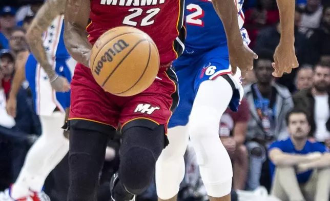 Miami Heat's Jimmy Butler, left, drives up the court with Philadelphia 76ers' Tobias Harris trailing during the first half of an NBA basketball play-in tournament game Wednesday, April 17, 2024, in Philadelphia. (AP Photo/Chris Szagola)