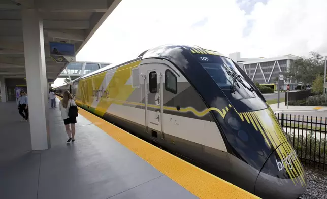 FILE - A Brightline train is shown at a station in Fort Lauderdale, Fla., on Jan. 11, 2018. A fast-tracked plan to build a high-speed passenger rail line between Las Vegas and the Los Angeles area is set to mark the start of construction. Brightline West and U.S. transportation secretary and other officials projecting that millions of ticket-buyers will be boarding trains by 2028. (AP Photo/Wilfredo Lee, File)