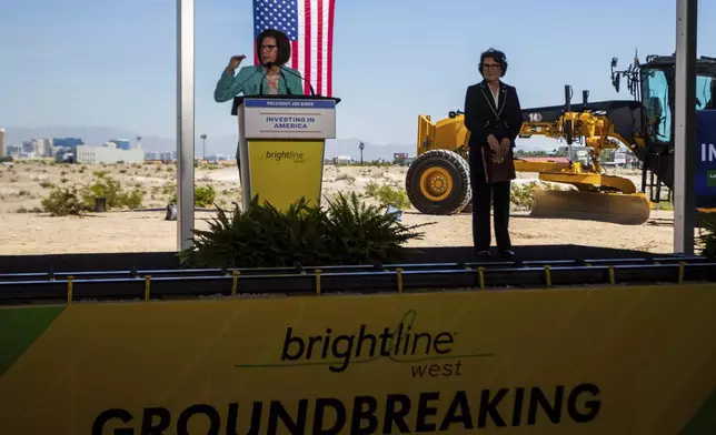 Sen. Catherine Cortez Masto, D-Nev., left, and Sen. Jacky Rosend, D-Nev., right, speak at the groundbreaking for a high-speed passenger rail on Monday, April 22, 2024, in Las Vegas. A $12 billion high-speed passenger rail line between Las Vegas and the Los Angeles area has started construction. (AP Photo/Ty ONeil)