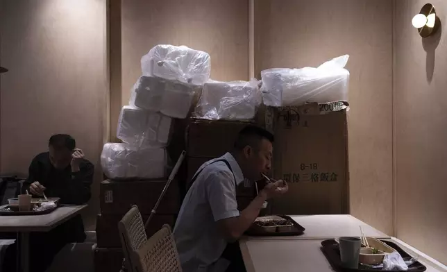 Customers eat food in disposable boxes at Kuen Fat Kitchen, a typical lunch stop, in Hong Kong, Wednesday, April 10, 2024. Hong Kong has long been a major producer and consumer of great food, and a great amount of plastic and Styrofoam to go with it. That’s going to change as new legislation aiming to stop the sale and distribution of Styrofoam products and single-use plastic cutlery went into effect on Monday, April 22, 2024.(AP Photo/Louise Delmotte)