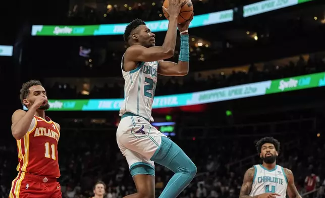 Charlotte Hornets forward Brandon Miller (24) heads to the basket against Atlanta Hawks guard Trae Young (11) during the first half of an NBA basketball game, Wednesday, April 10, 2024, in Atlanta. (AP Photo/Mike Stewart)
