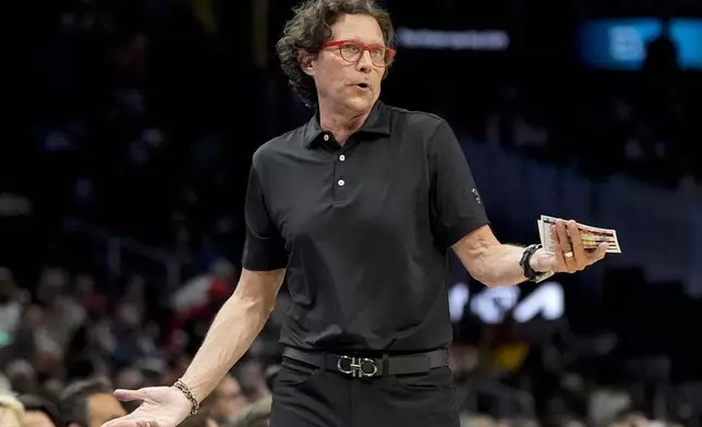 Atlanta Hawks head coach Quin Snyder speaks to a player during the first half of an NBA basketball game against the Charlotte Hornets, Wednesday, April 10, 2024, in Atlanta. (AP Photo/Mike Stewart)