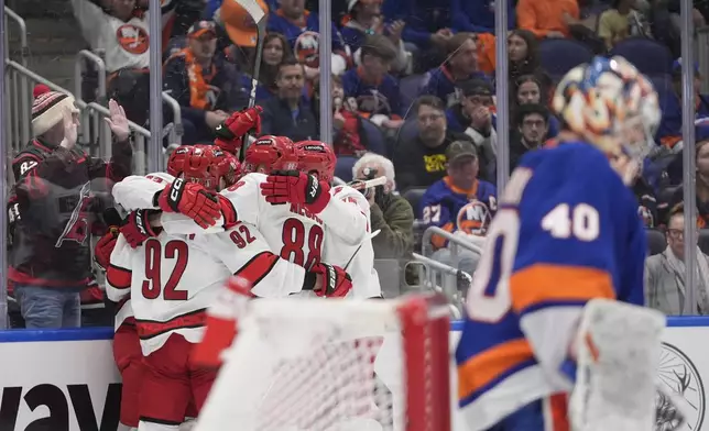 The Carolina Hurricanes celebrate a goal by Stefan Noesen as New York Islanders goaltender Semyon Varlamov (40) loolks away during the third period of Game 4 of an NHL hockey Stanley Cup first-round playoff series Saturday, April 27, 2024, in Elmont, N.Y. (AP Photo/Frank Franklin II)