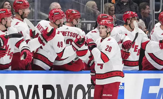 Carolina Hurricanes' Sebastian Aho celebrates with teammates after scoring a goal against the New York Islanders during the second period of Game 3 of an NHL hockey Stanley Cup first-round playoff series Thursday, April 25, 2024, in Elmont, N.Y. (AP Photo/Frank Franklin II)