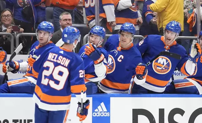 New York Islanders' Brock Nelson is congratulated for a goal against the Carolina Hurricanes during the second period of Game 3 of an NHL hockey Stanley Cup first-round playoff series Thursday, April 25, 2024, in Elmont, N.Y. (AP Photo/Frank Franklin II)