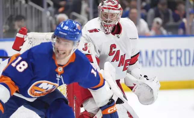 Carolina Hurricanes goaltender Frederik Andersen protects the net as New York Islanders' Pierre Engvall skates in front of him during the second period of Game 3 of an NHL hockey Stanley Cup first-round playoff series Thursday, April 25, 2024, in Elmont, N.Y. (AP Photo/Frank Franklin II)