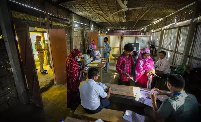 Voters line up to vote in a polling station during the second round of voting in the six-week-long national election in Morigaon district, Assam, India, Friday, April 26, 2024. (AP Photo/Anupam Nath)