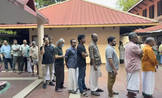 People queue up to vote during the second round of voting in the six-week long national election outside a polling booth in Kochi, southern Kerala state, India, Friday, April 26, 2024. (AP Photo/R S Iyer)