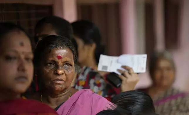 People queue up to vote during the second round of voting in the six-week-long national election near Palakkad, in Indian southern state of Kerala, Friday, April 26, 2024. (AP Photo/Manish Swarup)