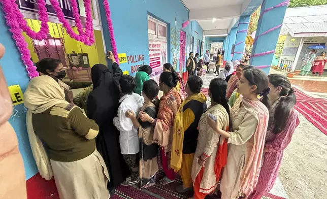 Women queue up to cast their votes during the first round of polling of India’s national election in Doda district, Jammu and Kashmir, India, Friday, April 19, 2024. (AP Photo/Channi Anand)