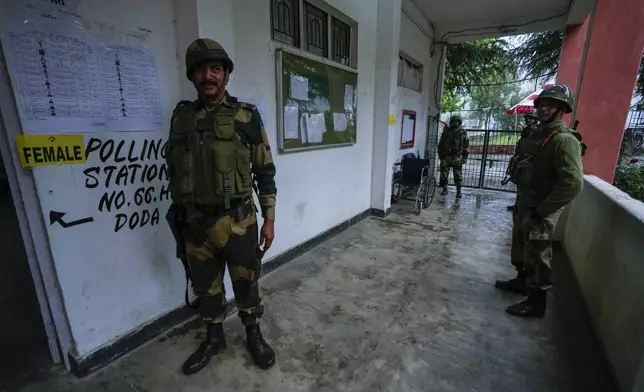 Paramilitary soldiers guard a polling station during the first round of polling of India’s national election in Doda district, Jammu and Kashmir, India, Friday, April 19, 2024. (AP Photo/Channi Anand)