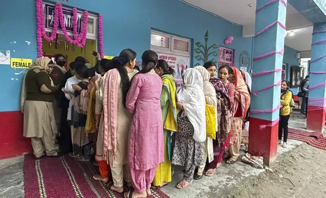 Women queue up to cast their votes during the first round of polling of India’s national election in Doda district, Jammu and Kashmir, India, Friday, April 19, 2024. (AP Photo/Channi Anand)
