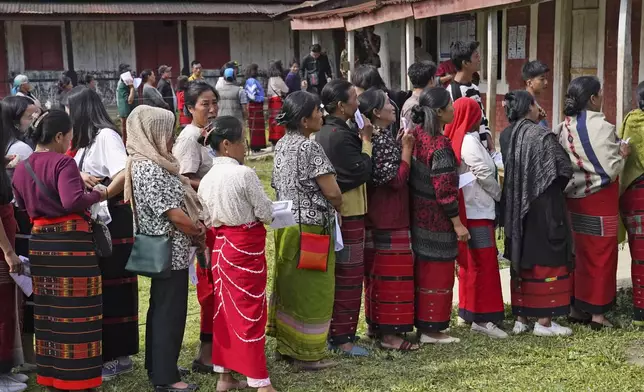 Tangkhul Nagas stand in a queue to cast their votes in Shangshak village, in the northeastern Indian state of Manipur, Friday, April 26, 2024. (AP Photo/Yirmiyan Arthur)