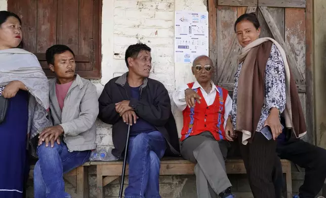 Tangkhul Nagas rest outside a polling station in Ukhrul, in the northeastern Indian state of Manipur, Friday, April 26, 2024. (AP Photo/Yirmiyan Arthur)