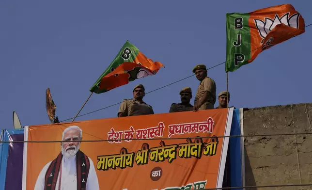 Security people stand guard on the top of a building during Indian Prime Minister Narendra Modi's election campaign for the upcoming national elections in Ghaziabad, India, April 6, 2024. India is in election mode with colorful, and frenzied, campaign underway by various political parties to woo voters across the country. From April 19 to June 1, nearly 970 million Indians or over 10% of the global population are eligible to vote in India's general election. (AP Photo/ Manish Swarup)