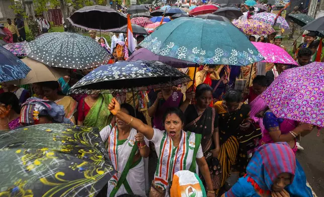 India's Congress party workers shout slogans during an election campaign rally ahead of the first phase of general elections in Titabor in upper Assam, India, Tuesday, April 16, 2024. (AP Photo/Anupam Nath)