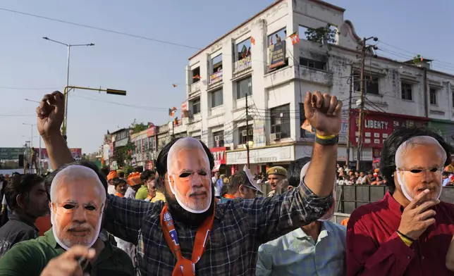 Supporters of Bharatiya Janata Party (BJP) wear Indian prime Minister Narendra Modi masks during an election campaign in Ghaziabad, India, April 6, 2024. India is in election mode with colorful, and frenzied, campaign underway by various political parties to woo voters across the country. From April 19 to June 1, nearly 970 million Indians or over 10% of the global population are eligible to vote in India's general election. (AP Photo/ Manish Swarup)