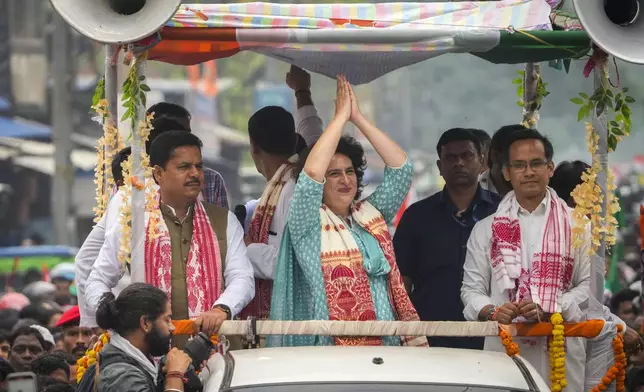India's Congress party leader Priyanka Gandhi waves during a road show as she campaigns for the upcoming national elections in Titabor in upper Assam, India, Tuesday, April 16, 2024. (AP Photo/Anupam Nath)