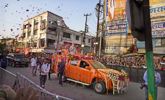 Indian Prime Minister Narendra Modi, center in a saffron cap, and Chief Minister of Uttar Pradesh Yogi Adityanath, in saffron robes, ride in an open vehicle as they campaign for Bharatiya Janata Party (BJP) for the upcoming parliamentary elections in Ghaziabad, India, April 6, 2024.India is in election mode with colorful, and frenzied, campaign underway by various political parties to woo voters across the country. From April 19 to June 1, nearly 970 million Indians or over 10% of the global population are eligible to vote in India's general election. (AP Photo/ Manish Swarup)