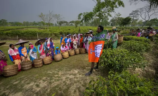 Chandra Saora, 45, a tea garden supervisor, campaigns for the Bharatiya Janata Party ahead of the first phase of national elections in Marioni in upper Assam, India, Tuesday, April 16, 2024. (AP Photo/Anupam Nath)