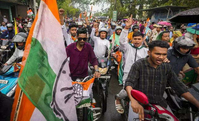 India's Congress party supporters take part in a bike rally during an election campaign ahead of national elections in Titabor in upper Assam, India, Tuesday, April 16, 2024. (AP Photo/Anupam Nath)