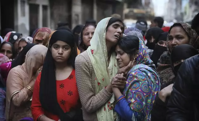 FILE- Relatives and neighbors mourn after a man was killed during violent clashes between Hindus and Muslims in New Delhi, India, Feb. 27, 2020. (AP Photo/Manish Swarup, File)