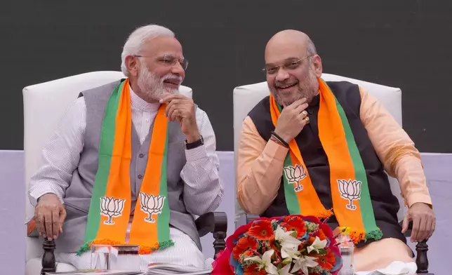 FILE - Indian Prime Minister Narendra Modi, left, and the president of the Bharatiya Janata Party, Amit Shah, in New Delhi, India, April 8, 2019. (AP Photo/Manish Swarup, File)